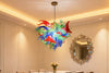 Vibrant multicolor hand-blown floral glass chandelier from SandiyArt hanging above an elegant dining table, Chihuly-style organic flower pendant light as a luxury statement decor for modern dining room interior